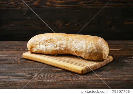 Freshly baked ciabatta on wooden table Freshly baked ciabatta on wooden table 79207706
