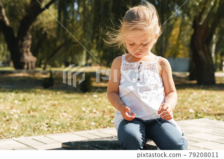 Close up portrait of a little blonde girl on a summer day 79208011