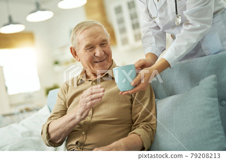 Happy aged man going to drink a hot drink at home Happy aged man going to drink a hot drink at home 79208213