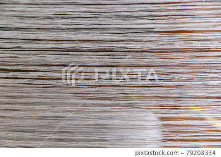 A seasoned weaving machine and silk thread that preserves tradition 79208334