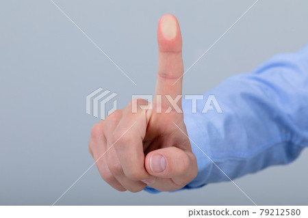 Midsection of caucasian businessman touching virtual interface, isolated on grey background 79212580