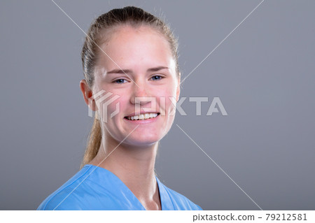 Portrait of caucasian female doctor looking at camera, isolated on grey background 79212581