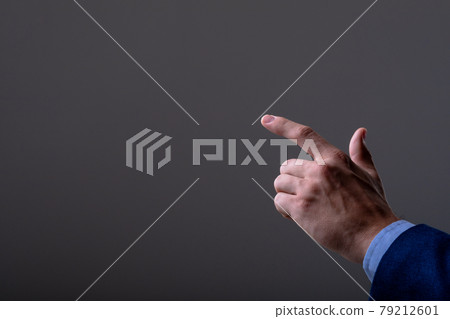 Midsection of caucasian businessman touching virtual interface, isolated on grey background 79212601