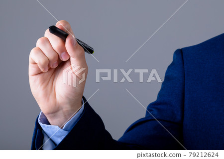 Midsection of caucasian businessman holding marker, isolated on grey background 79212624