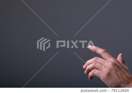 Midsection of caucasian businessman touching virtual interface, isolated on grey background 79212684