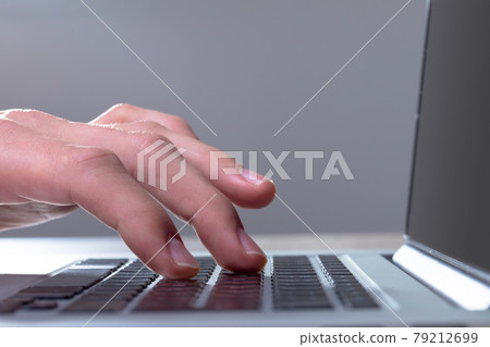 Close up of caucasian businessman typing on keyboard, isolated on grey background 79212699
