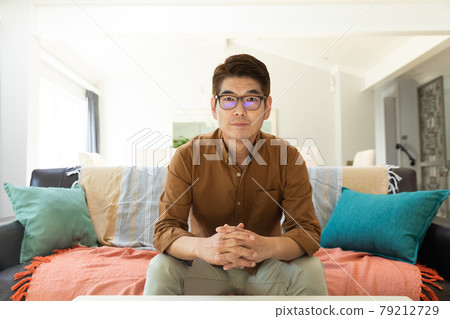 Asian man during video call at home 79212729