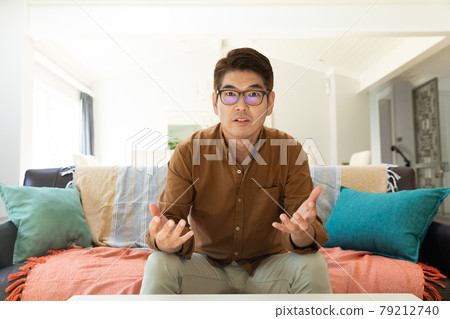 Asian man during video call at home 79212740
