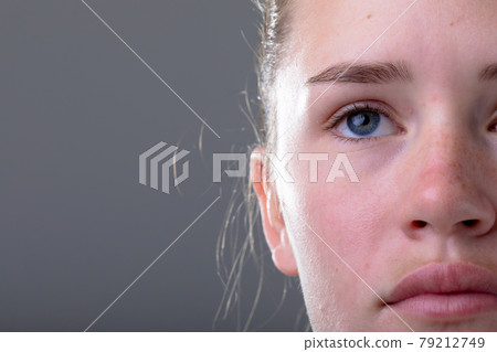 Close up of face of caucasian businesswoman, isolated on grey background Close up of face of caucasian businesswoman, isolated on grey background 79212749