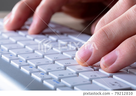 Close up of caucasian businessman typing on keyboard, isolated on grey background 79212810