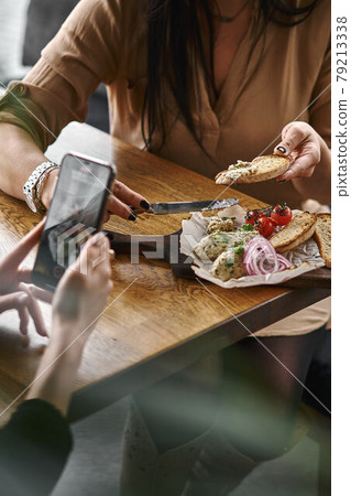 Female hands hold minced herring fillet with apple and egg on toasted bread, traditional Jewish cuisine dish forshmak Female hands hold minced herring fillet with apple and egg on toasted bread, traditional Jewish cuisine dish forshmak 79213338
