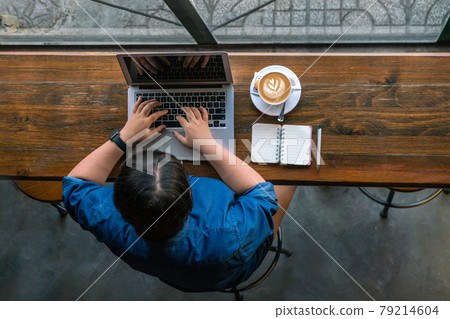 Aerial view of Asian woman working on laptop 79214604