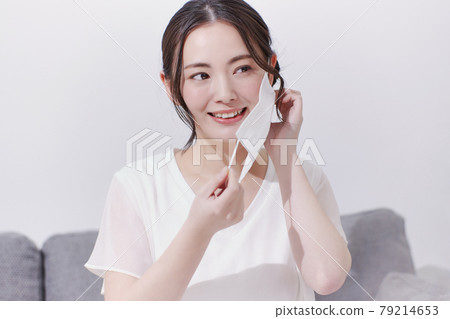 A smiling young woman who removes the mask 79214653