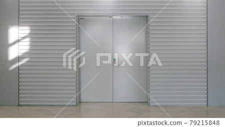 Wall surface (white door) surrounded by bright light 79215848