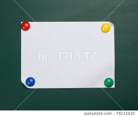 blank white sheet of a4 paper hanging on a green magnetic board. blank white sheet of a4 paper hanging on a green magnetic board. 79215920