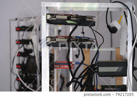 Many video cards are assembled into mining farm for cryptocurrency closeup Many video cards are assembled into mining farm for cryptocurrency closeup 79217285