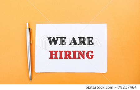 Notes with the inscription We are hiring and a pen. Employee Search. Attraction to work. Human Resource Management. Hire. Promotion. Working staff. Business concept 79217464