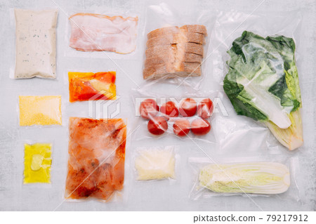Salad dinner set: chicken, lettuce, tomatoes, peking cabbage, cheese, bacon, bread, olive oil sauces and spices. A set for delivering food for dinner on a white background. I cook at home. 79217912