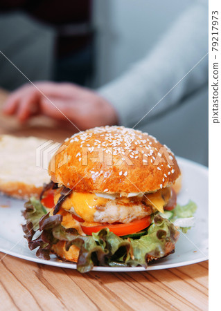 Burgers with beef and vegetables. Delicious burgers in a cooking class. Burger with onion sauce. Burgers with beef and vegetables. Delicious burgers in a cooking class. Burger with onion sauce. 79217973