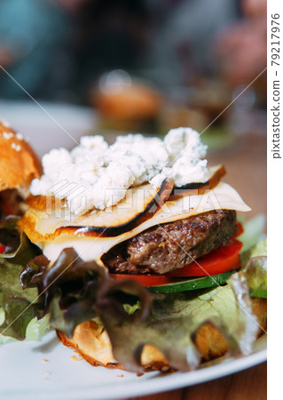 Burgers with beef and vegetables. Delicious burgers in a cooking class. Burger with onion sauce. 79217976