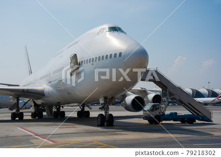 Airplane near the terminal in an airport Airplane near the terminal in an airport 79218302