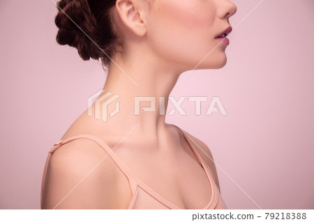 Portrait of beautiful young woman isolated on light pink studio background. Concept of female beauty, style, makeup 79218388