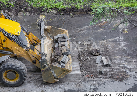 Specialized bulldozer for road repair and paving. In action Specialized bulldozer for road repair and paving. In action 79219133
