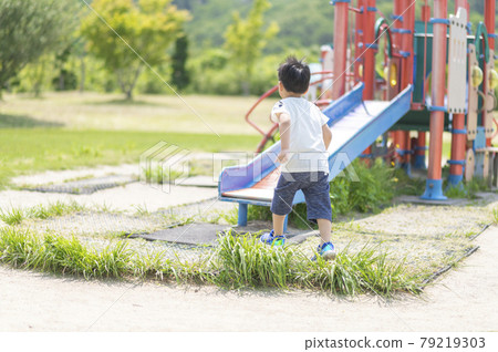 4-year-old boy running around the park 79219303