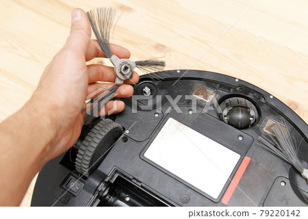 dirty round robot vacuum cleaner with dirty brushes wrapped in hair dirty round robot vacuum cleaner with dirty brushes wrapped in hair 79220142