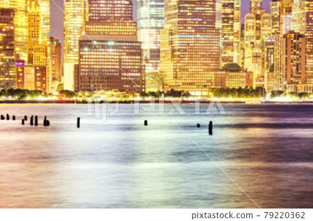 Defocused picture of Manhattan waterfront at night, abstract urban background, New York City, USA. Defocused picture of Manhattan waterfront at night, abstract urban background, New York City, USA. 79220362