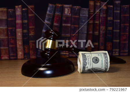 Judge hammer and bundles of dollars. Justice in courtroom. Mallet of judge on law theme and legal system.  79221967