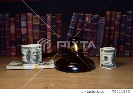 Judge hammer and bundles of dollars. Justice in courtroom. Mallet of judge  79221970