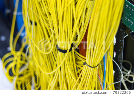 The yellow network cables in the server room for connecting to a network internet The yellow network cables in the server room for connecting to a network internet 79222266