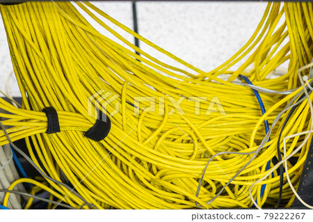 The yellow network cables in the server room for connecting to a network internet The yellow network cables in the server room for connecting to a network internet 79222267