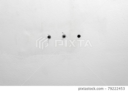 Hole and dowels in an old dirty white wall. Dowel pin inside old peeled wall for different editing projects Hole and dowels in an old dirty white wall. Dowel pin inside old peeled wall for different editing projects 79222453