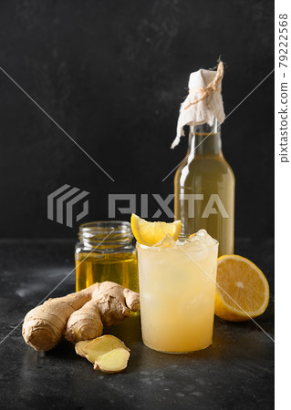 Homemade Kombucha healthy tasty drink in bottle and glass with lemon garnish mint. Homemade Kombucha healthy tasty drink in bottle and glass with lemon garnish mint. 79222568