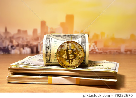 Bitcoin coins on a bundle with dollars. Bitcoin coins on a bundle with dollars. 79222670