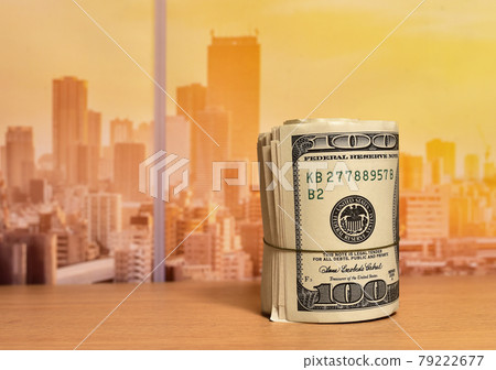 Money roll dollars on wooden table in office.  79222677