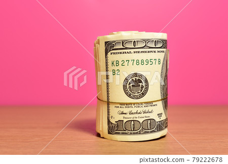 Money roll dollars on wooden table in office.  79222678