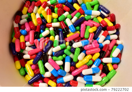Multi-colored pills in capsules. Multicolored pharmaceutical pills, medical tablets and capsules. Multi-colored pills in capsules. Multicolored pharmaceutical pills, medical tablets and capsules. 79222702