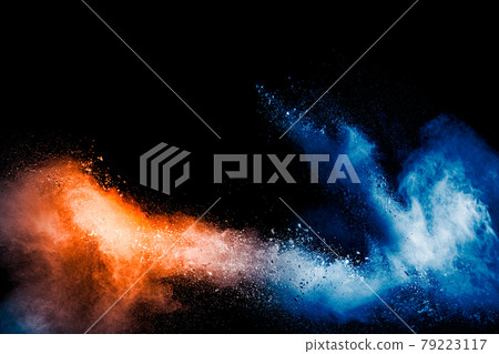 Orange blue color powder explosion on black background. Orange blue color powder explosion on black background. 79223117