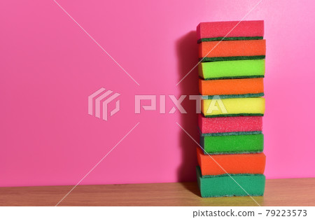 Sponge for washing dishes and plumbing on a pink background.  79223573