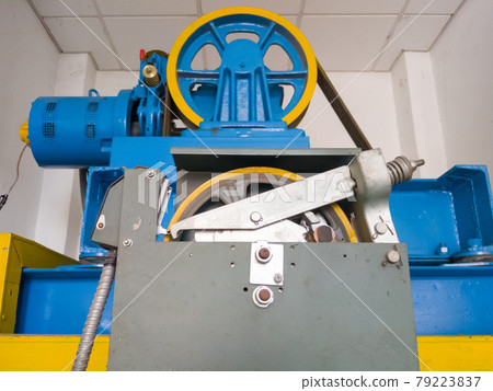 The large circle wheel of the passenger elevator motor in the control room. The large circle wheel of the passenger elevator motor in the control room. 79223837