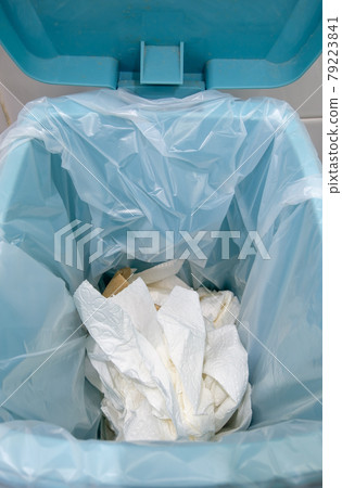 Closeup of the many used toilet paper in the plastic bag on the trashcan. 79223841