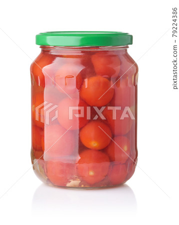 Front view of canned cherry tomatoes in glass jar 79224386