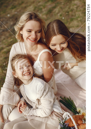 Elegant mother with children in a summer forest 79224784