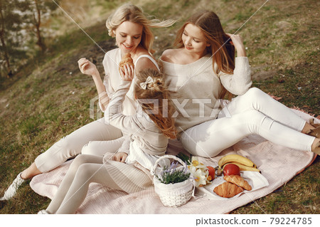 Elegant mother with children in a summer forest Elegant mother with children in a summer forest 79224785