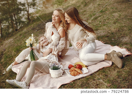Elegant mother with children in a summer forest 79224786