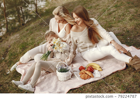 Elegant mother with children in a summer forest 79224787