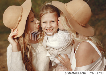 Elegant mother with children in a summer forest Elegant mother with children in a summer forest 79224790